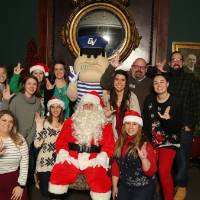 Young Alumni Council members posing with Santa and Louie the Laker